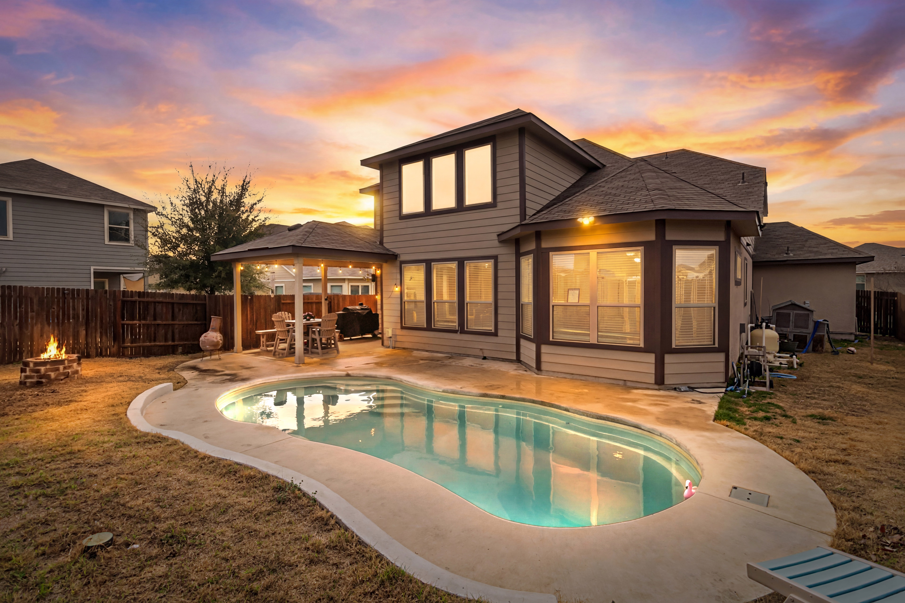 Virtual twilight exterior with sunset and illuminated pool